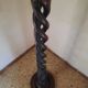 Sculptural floor lamp made of twisted turned wood.