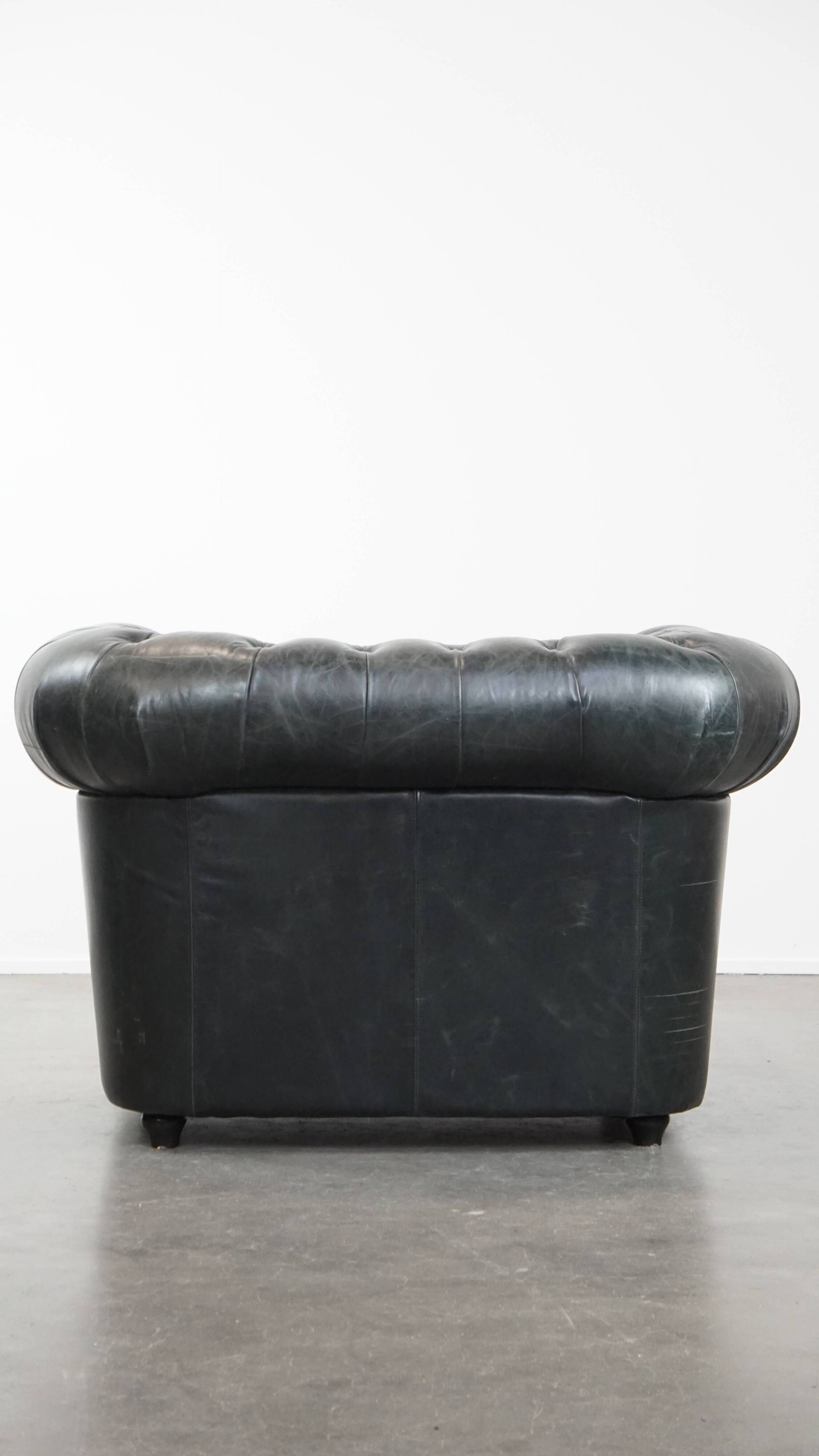 Black Chesterfield armchair made of grained cowhide leather