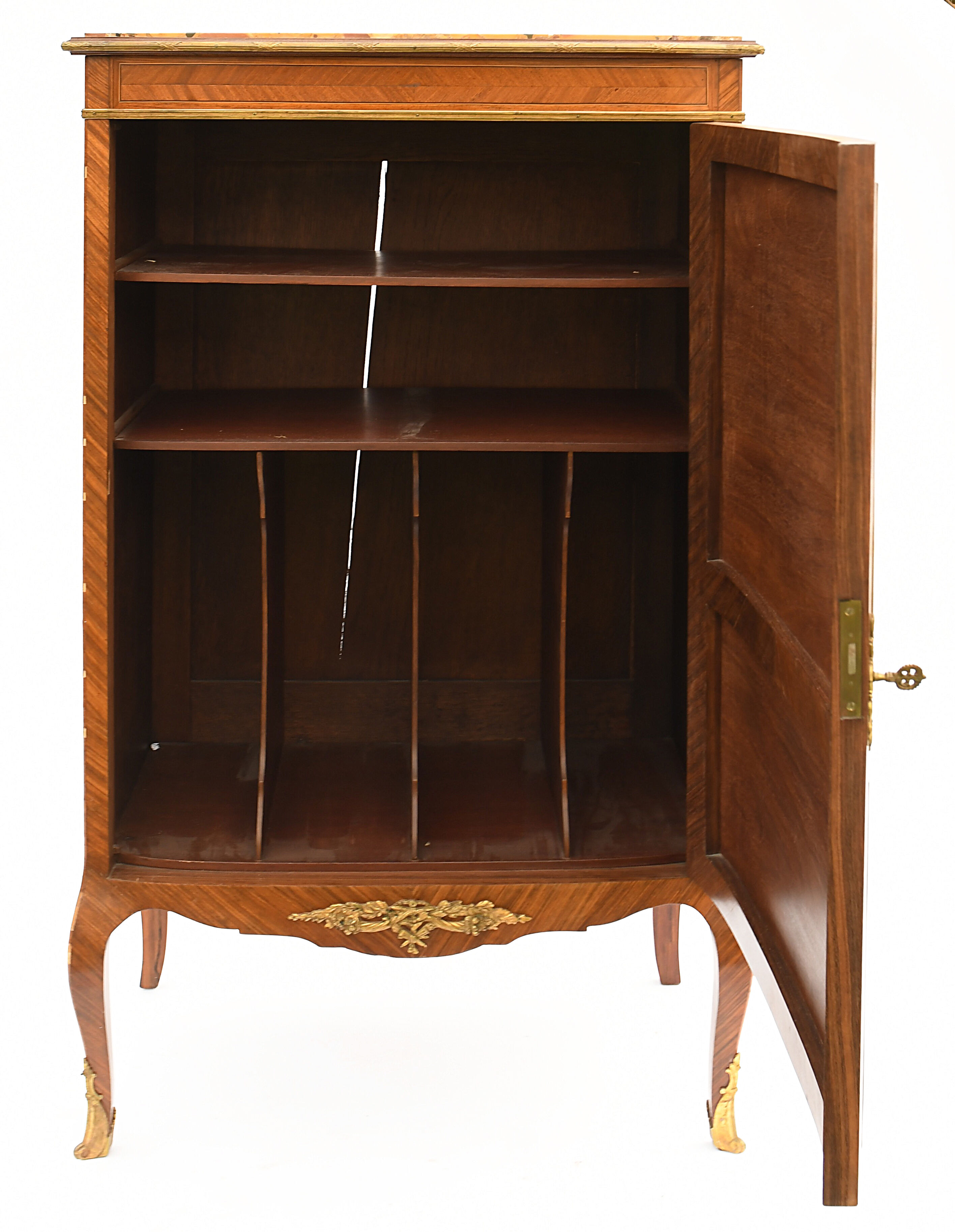 In-between furniture in marquetry decorated with a trophy decoration of musical instruments
