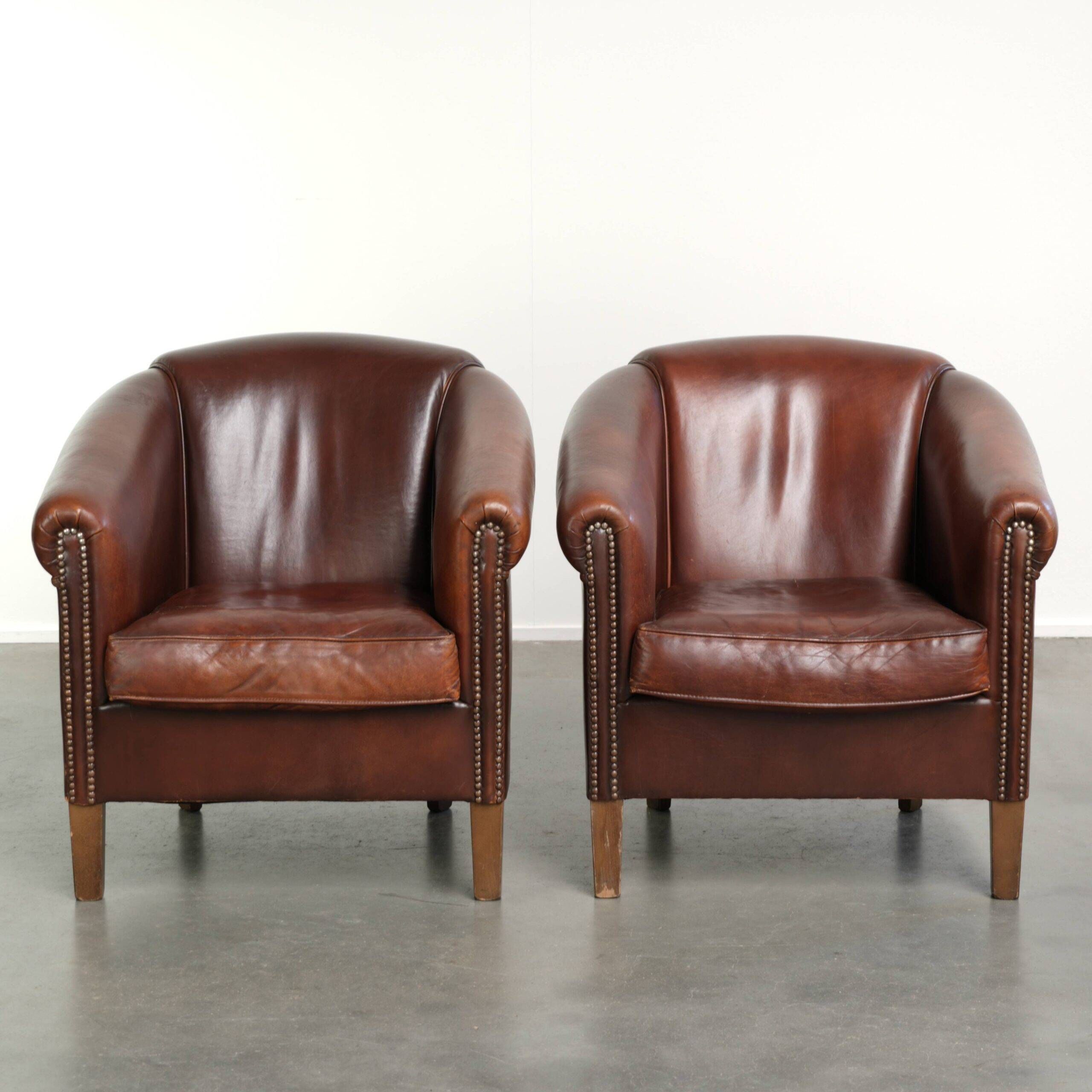 Set of 2 sheepskin club armchairs in a dark cognac colour