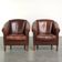 Set of 2 sheepskin club armchairs in a dark cognac colour