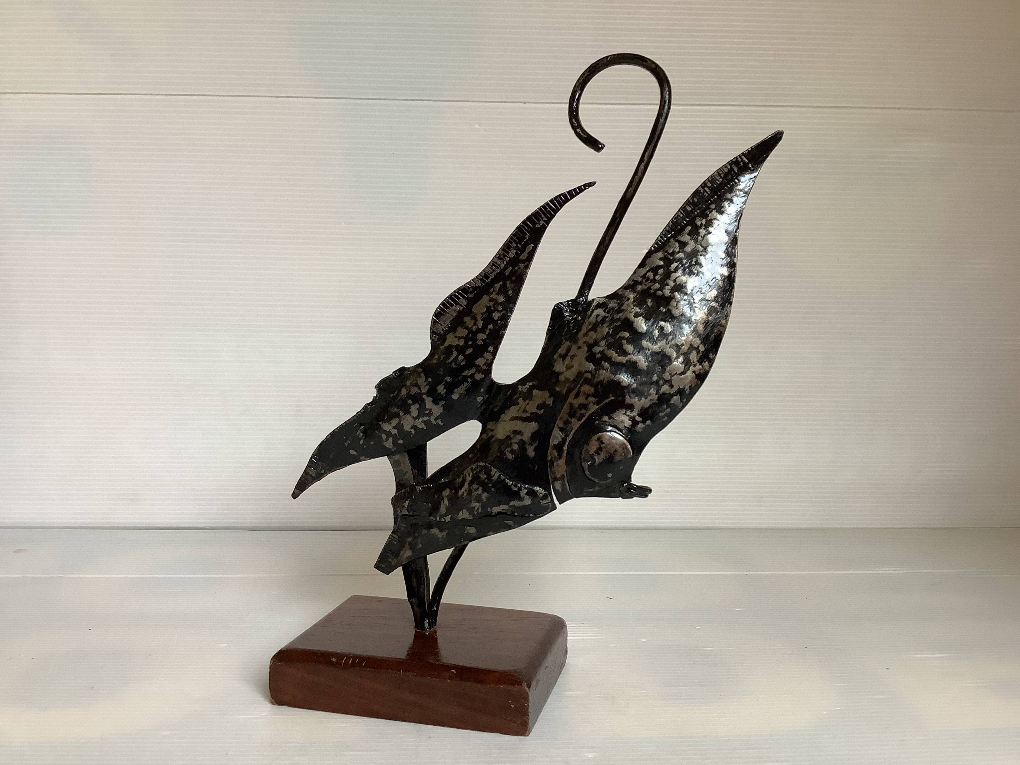 Small metal and wood fish statue