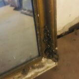 Old mirror with gilded leaves and flowers carved on top of it 1800s