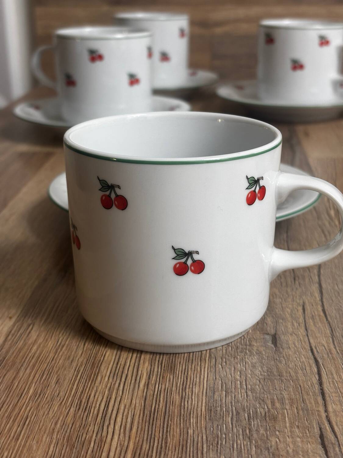 Set of 4 large cherry porcelain cups and saucers.