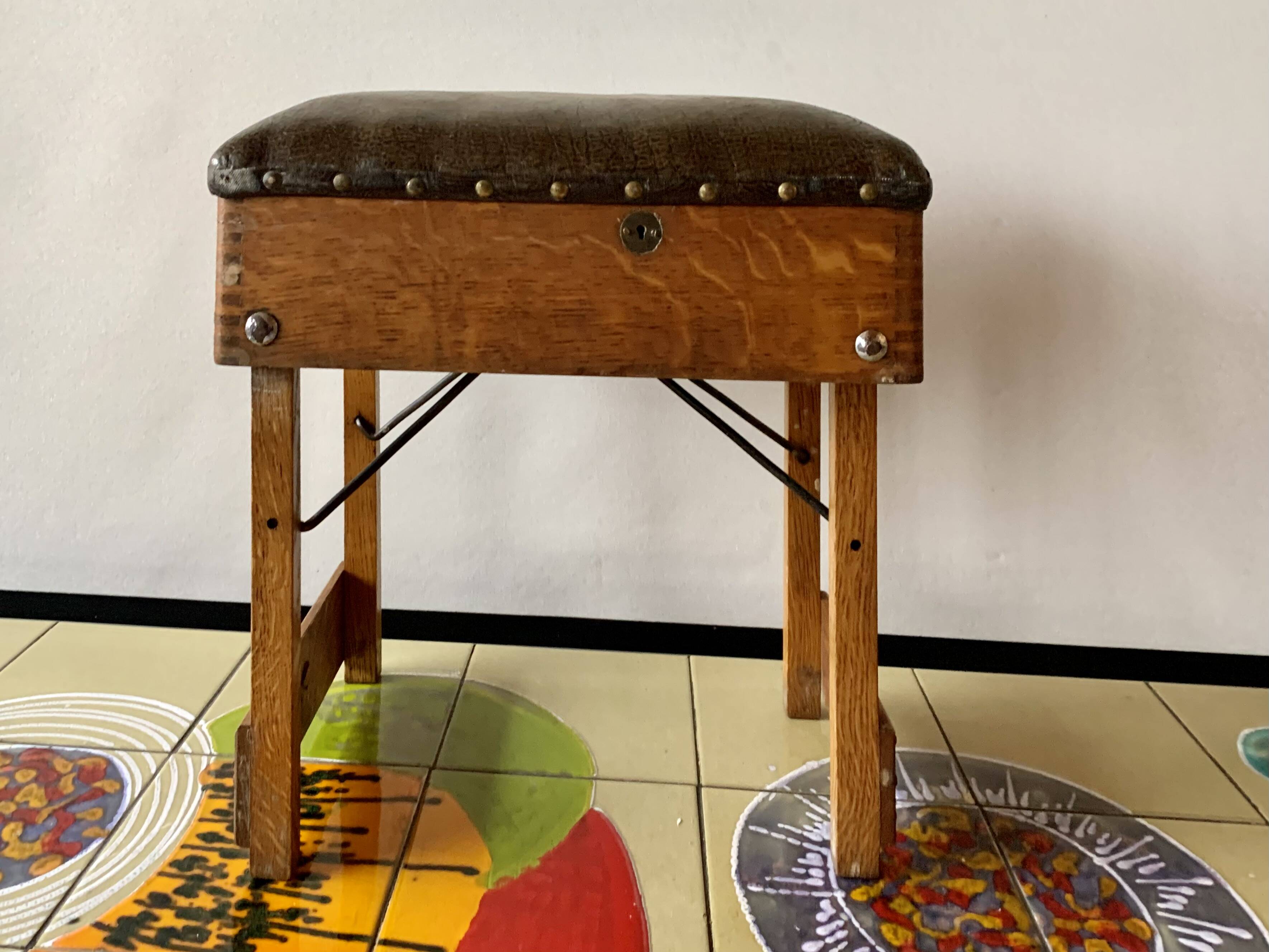 Old foldable fisherman's stool in wood and leather