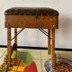 Old foldable fisherman's stool in wood and leather