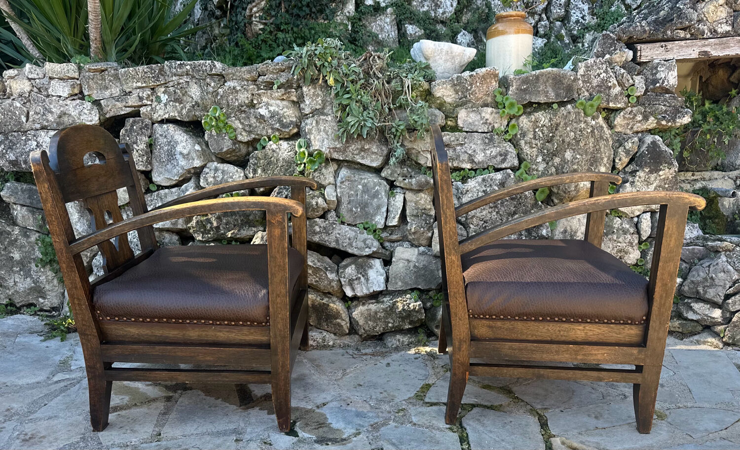 Pair of armchairs in stained wood and leather, 20th century