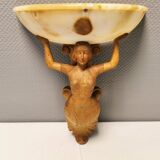 Wall lamp, where the base is a carved wooden lady holding the shade which is made of alabaster 1920s