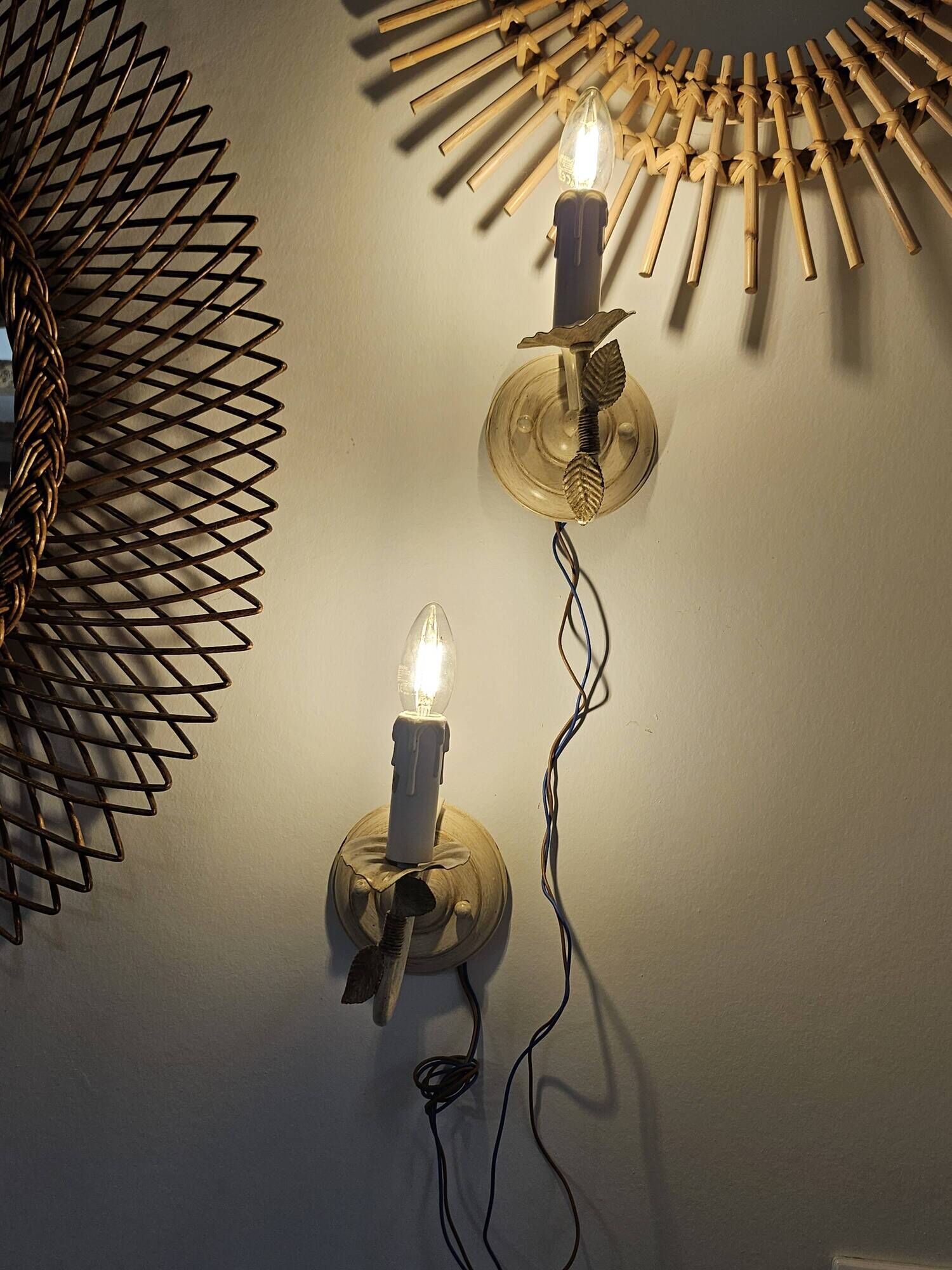 Pair of cream patinated metal wall sconces with floral decoration.