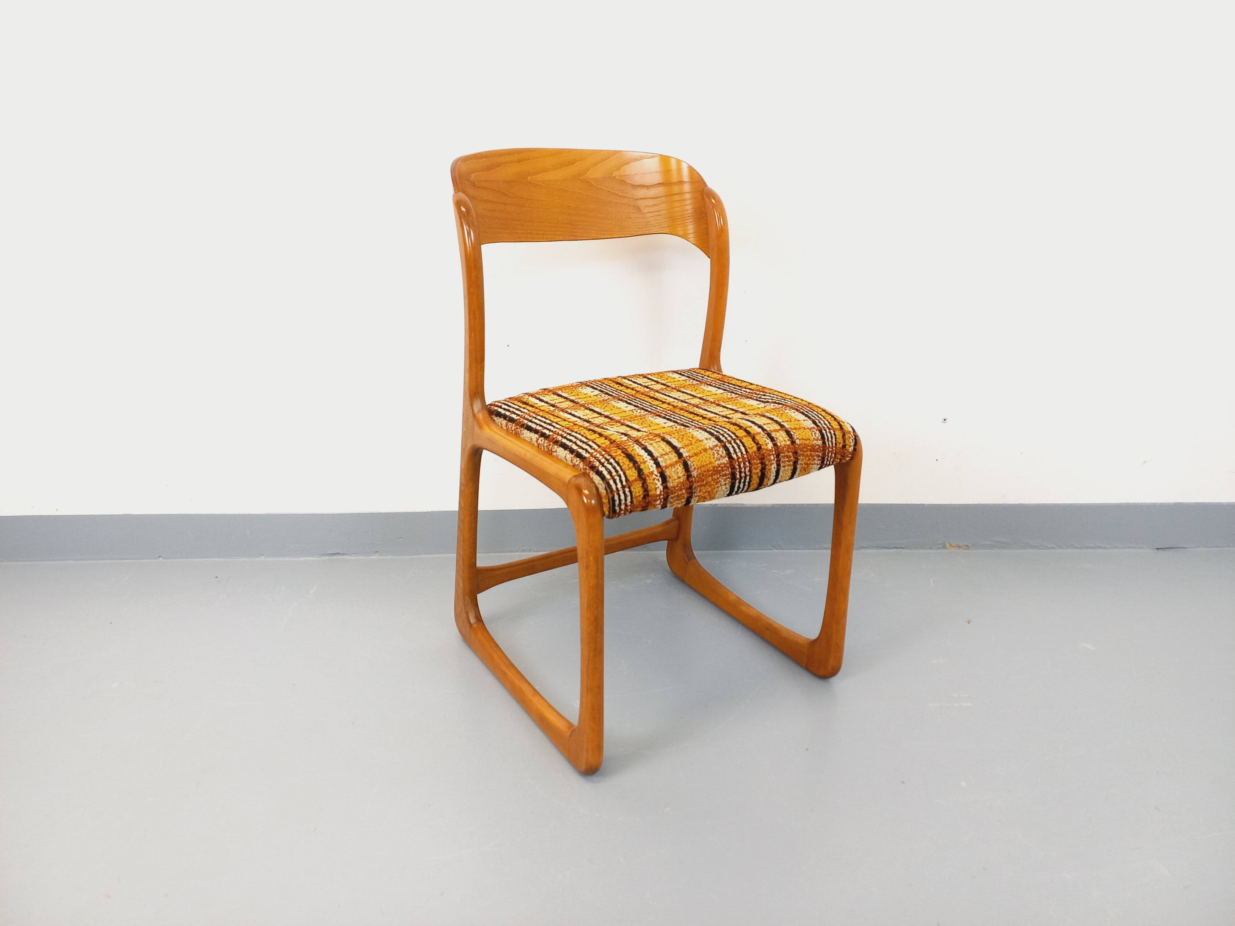 Vintage sled chair by Baumann in wood and wool fabric.