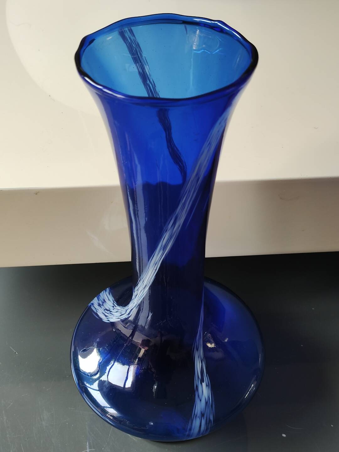 Long flared neck ball vase. Smoked scrolls in cobalt blue art glass, 30cm