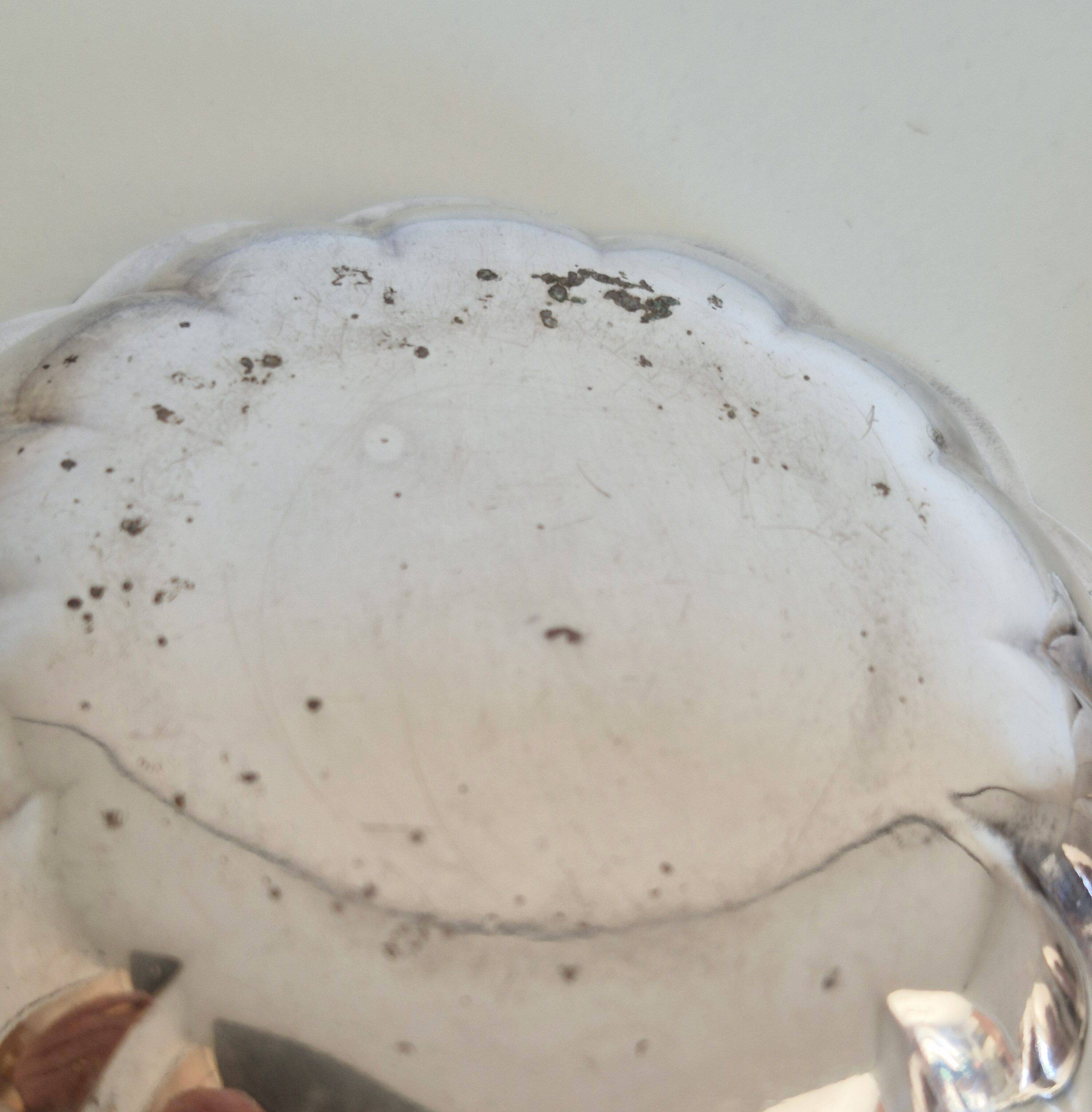 Silver-plated shell-shaped butter dishes, in the shape of a scallop shell.
