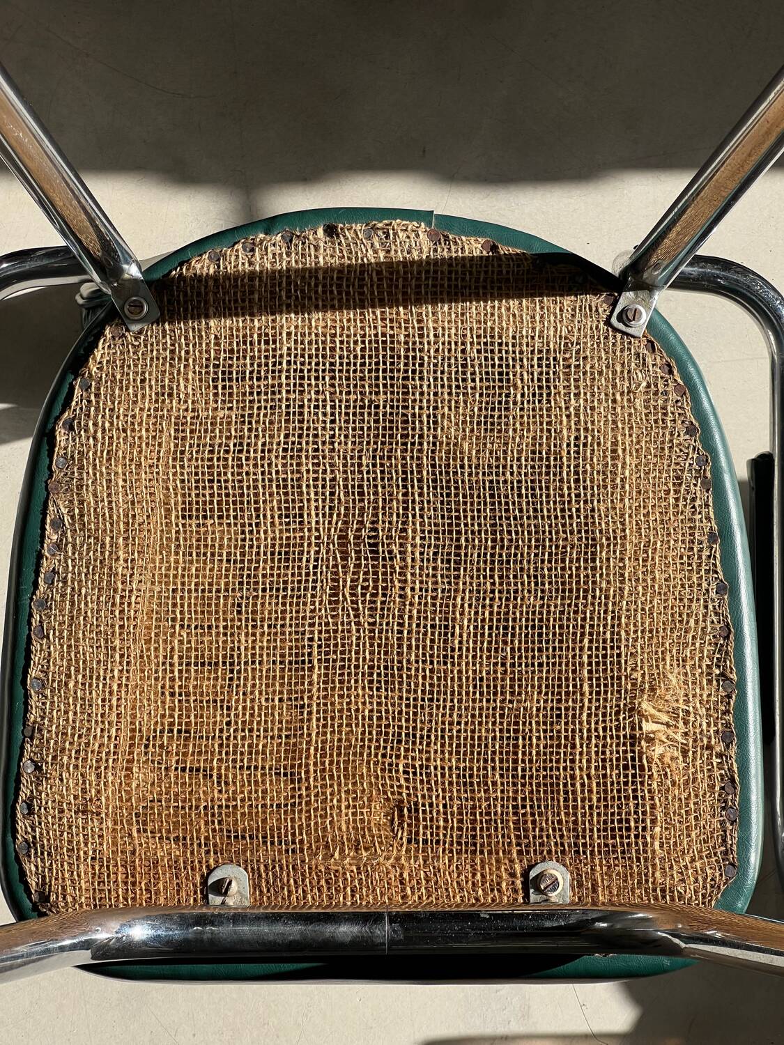 Pair of green vinyl and chrome armchairs, mid-century
