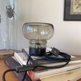 Sciolari table lamp with smoked glass globe and black plastic base.