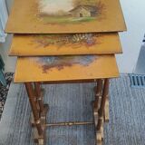 Sets of three nesting tables with painted landscape decorations in poplar.