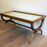 Coffee table in patinated and gilded carved wood with mirror top