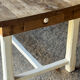 Farm table in solid oak - white patinated legs and its bench.