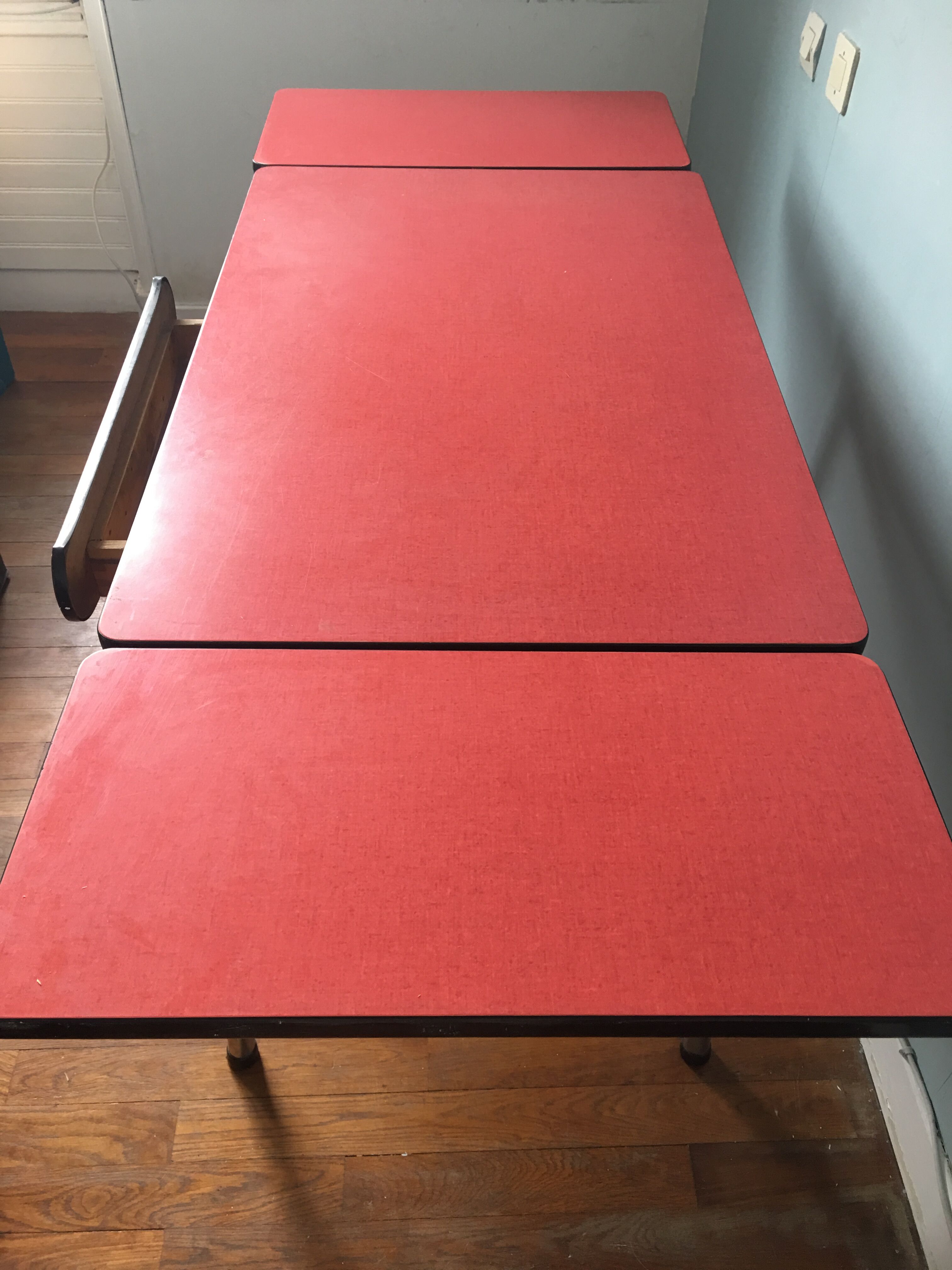 Large table in red formica with extensions + red drawer