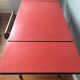 Large table in red formica with extensions + red drawer