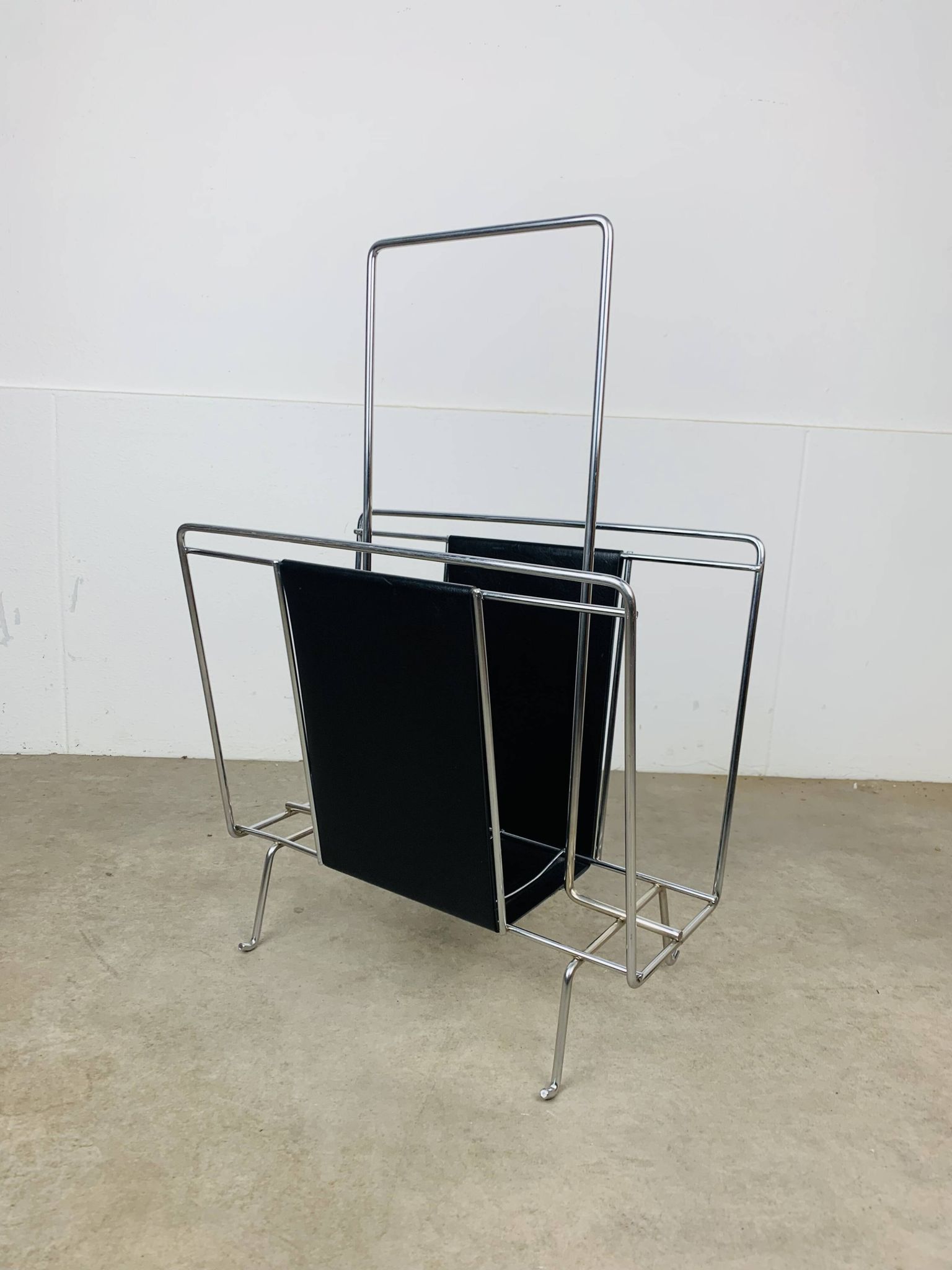 Chrome and black leather magazine rack, 1970s.
