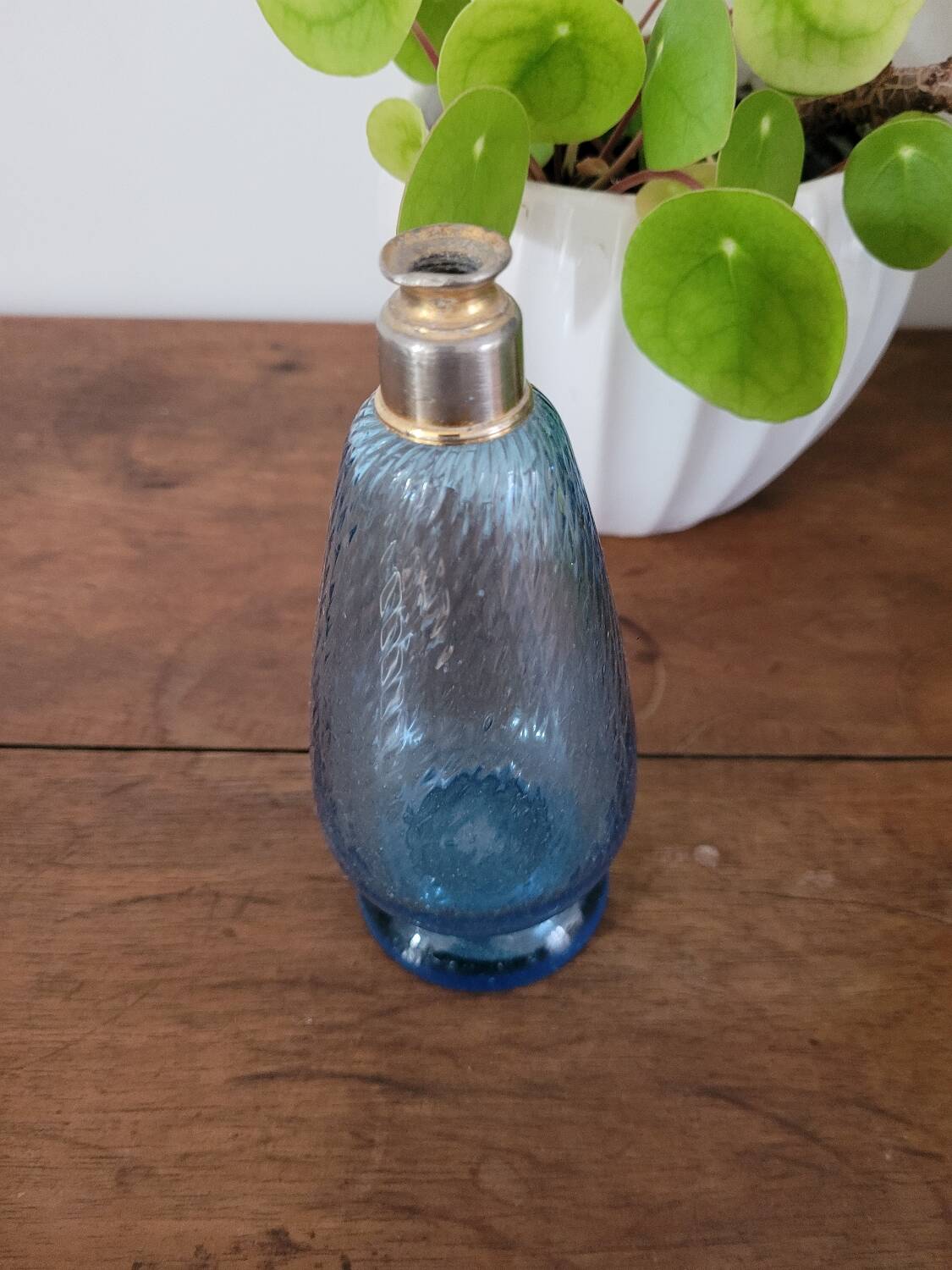 Small blue twisted glass bottle