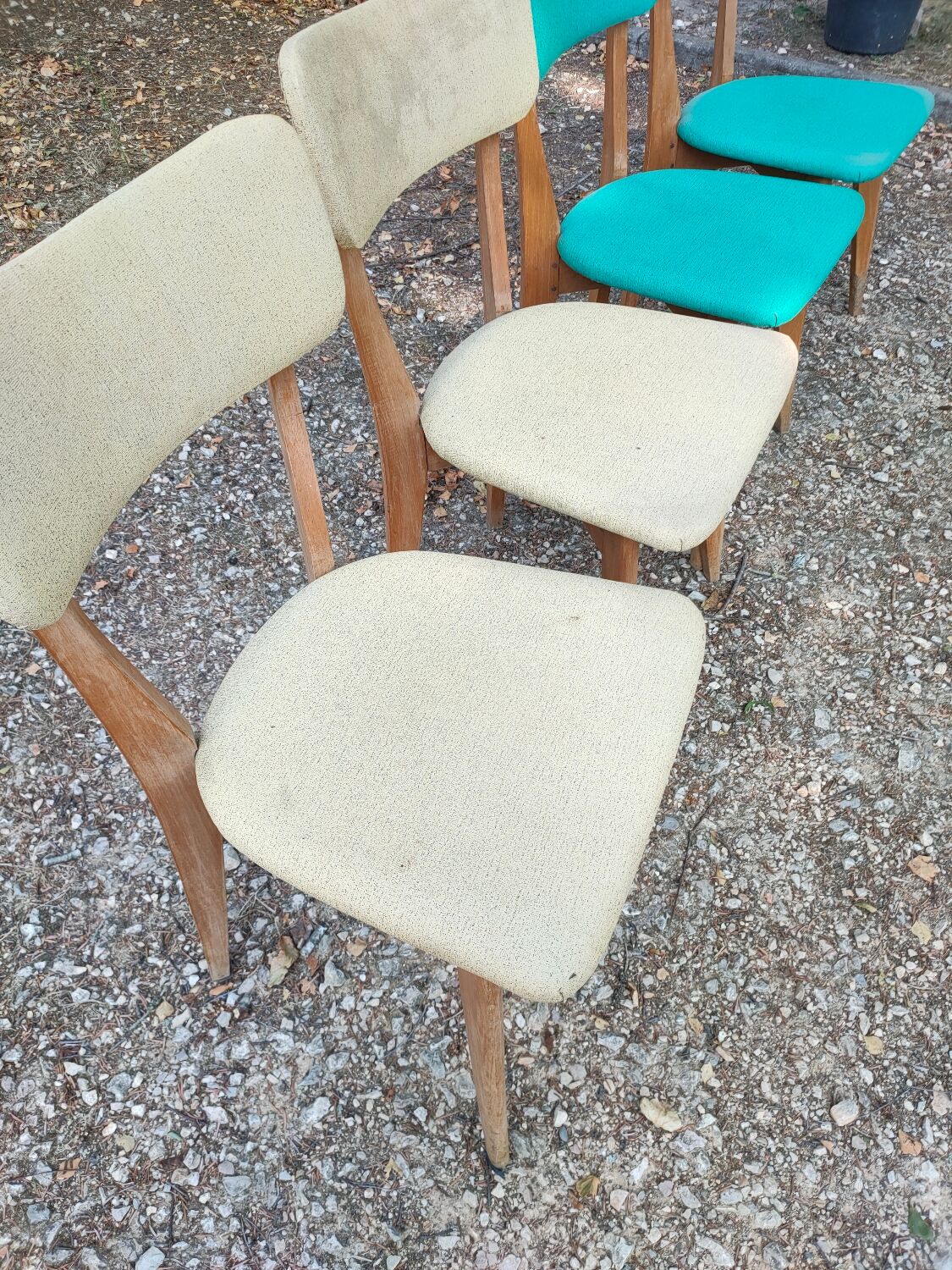 Set of 4 vintage chairs in wood and imitation blue leather dating from the 50s. Wooden structure. Seat and backrest in imitation leather 2 mint green and 2 yellow. Seating dimension: 46 cm. Good state of conservation, some traces of wear.