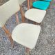 Set of 4 vintage chairs in wood and imitation blue leather dating from the 50s. Wooden structure. Seat and backrest in imitation leather 2 mint green and 2 yellow. Seating dimension: 46 cm. Good state of conservation, some traces of wear.