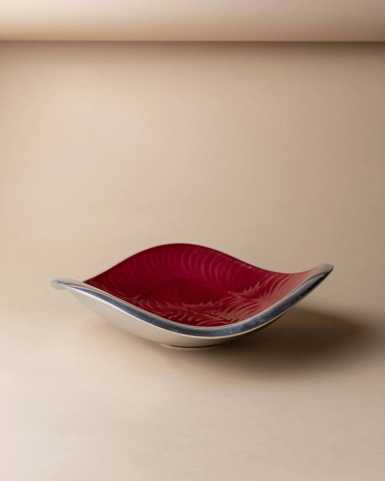 Red enameled steel bowl with textured interior and silver exterior; vintage Italian 1970s design