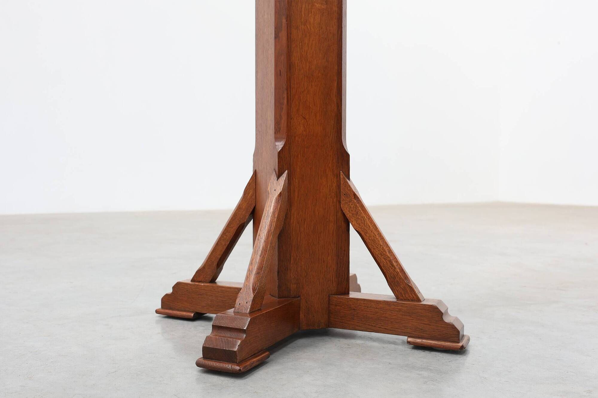 Art Deco oak pedestal with pierced brackets and cross base, Belgium 1920s