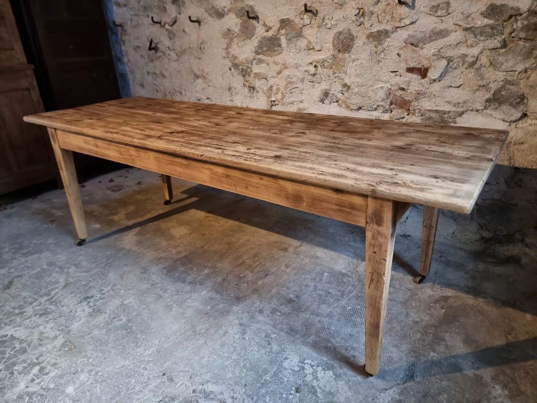 Antique French pine dining table, large farmhouse table on wheels, 19th century.