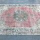 Tapis rose pâle avec médaillon