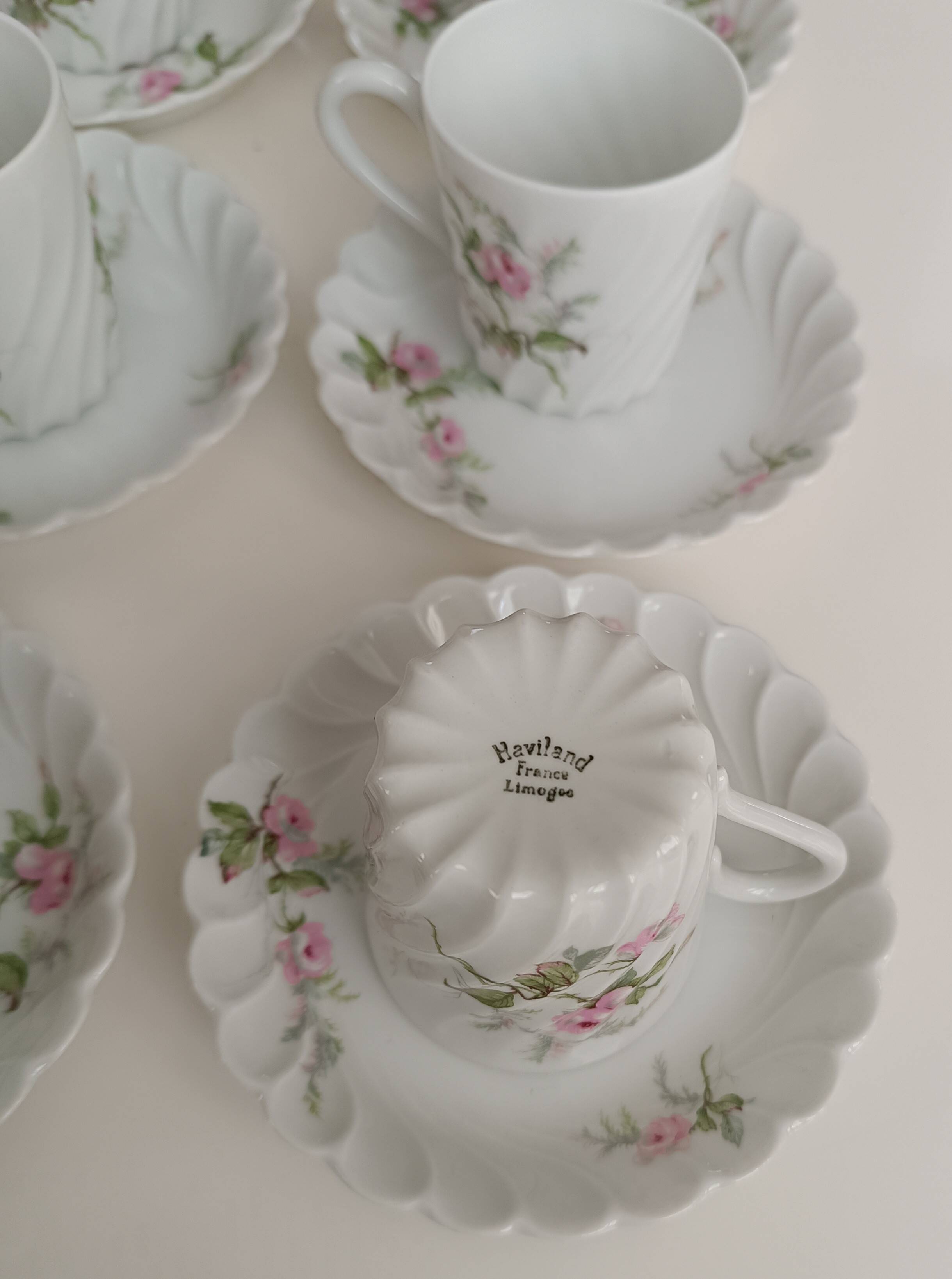 Haviland Limoges porcelain 10 coffee cups and 9 saucers with floral decoration.