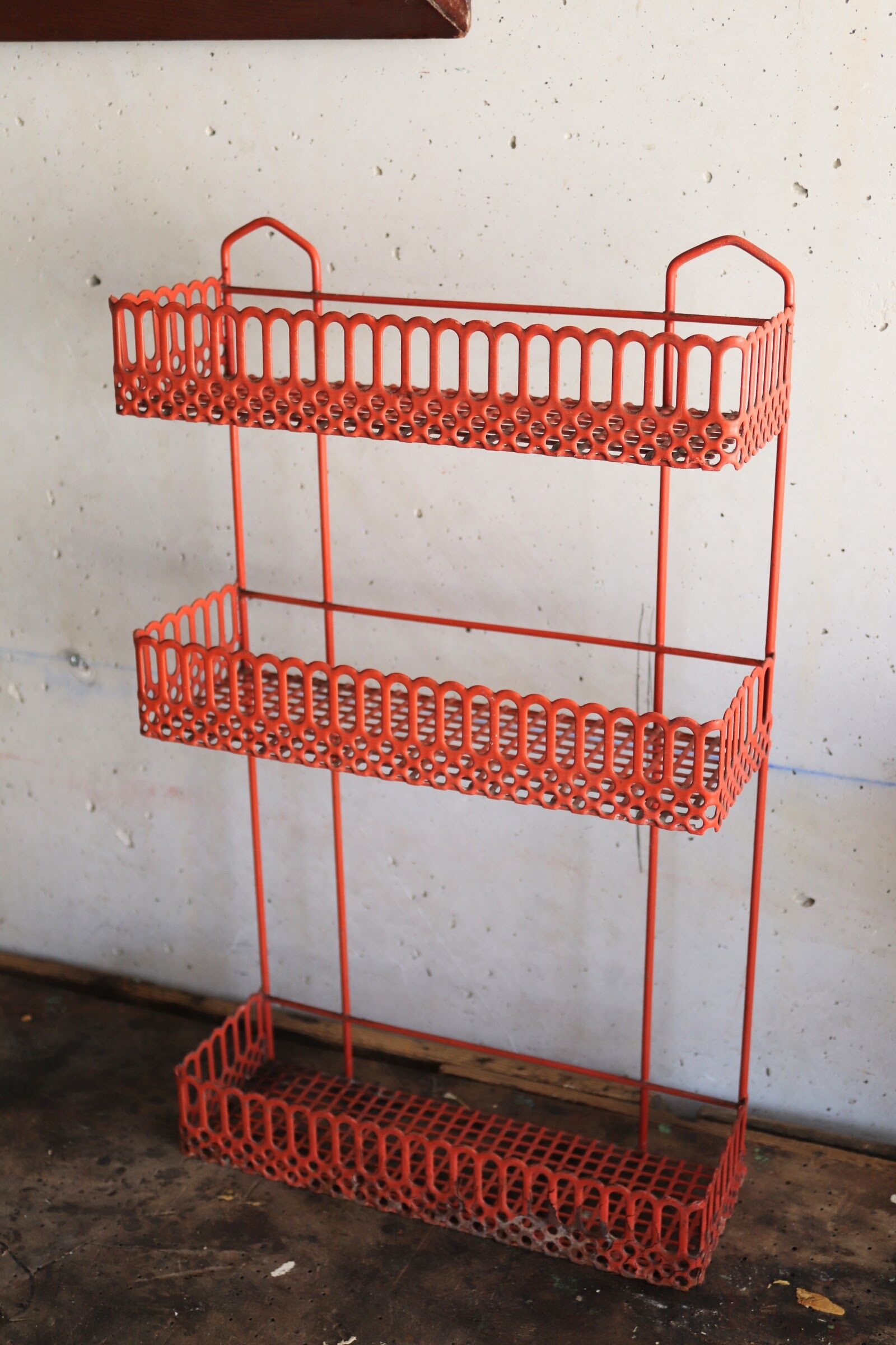 Vintage shelf in red openwork metal