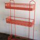Vintage shelf in red openwork metal