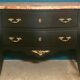 Louis XV style curved black matte commode with gilded bronze ornamentation from the 1950s.