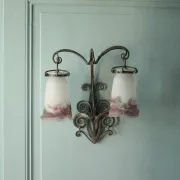 Wall lamp in wrought iron with a pink tulip glass globe by Muller glassworks.