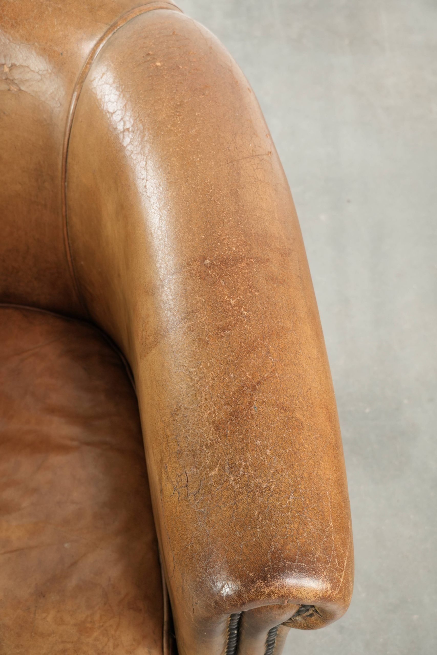 Vintage sheepskin club armchair finished with decorative nails