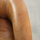 Vintage sheepskin club armchair finished with decorative nails