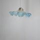 Suspension lampshade with scalloped edges in blue and its interior decoration.
