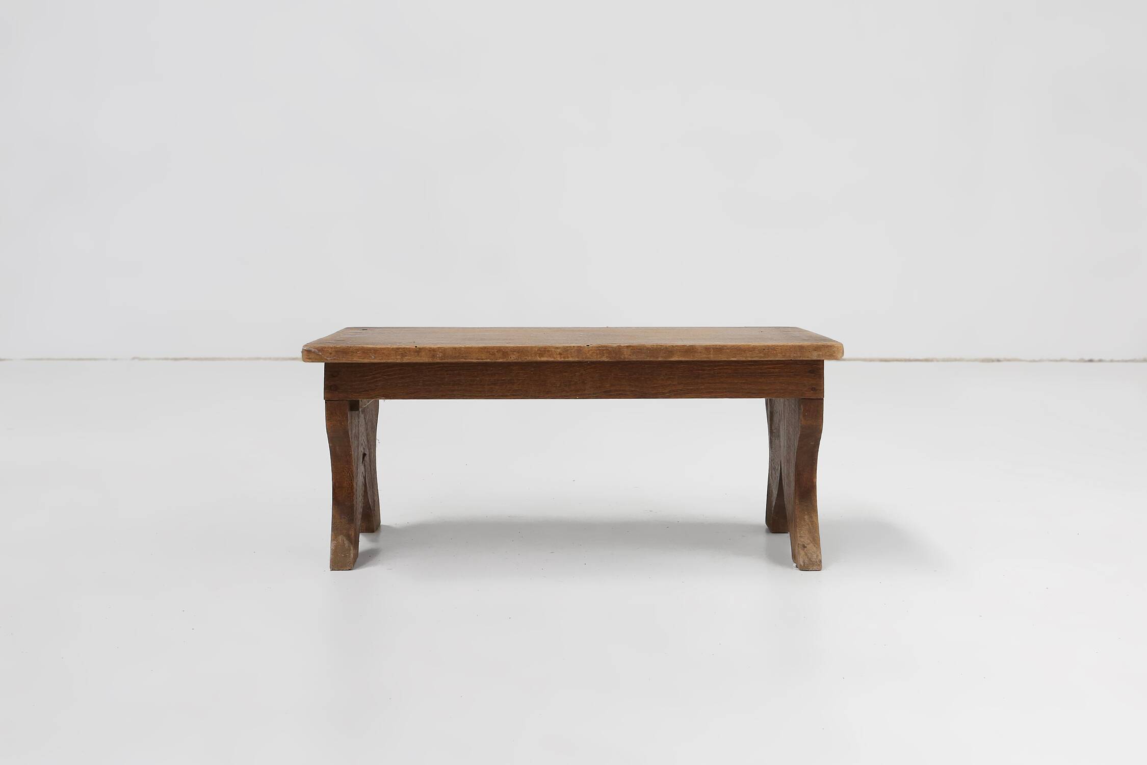 Small rustic wooden stool with curved base, France ca. 1900