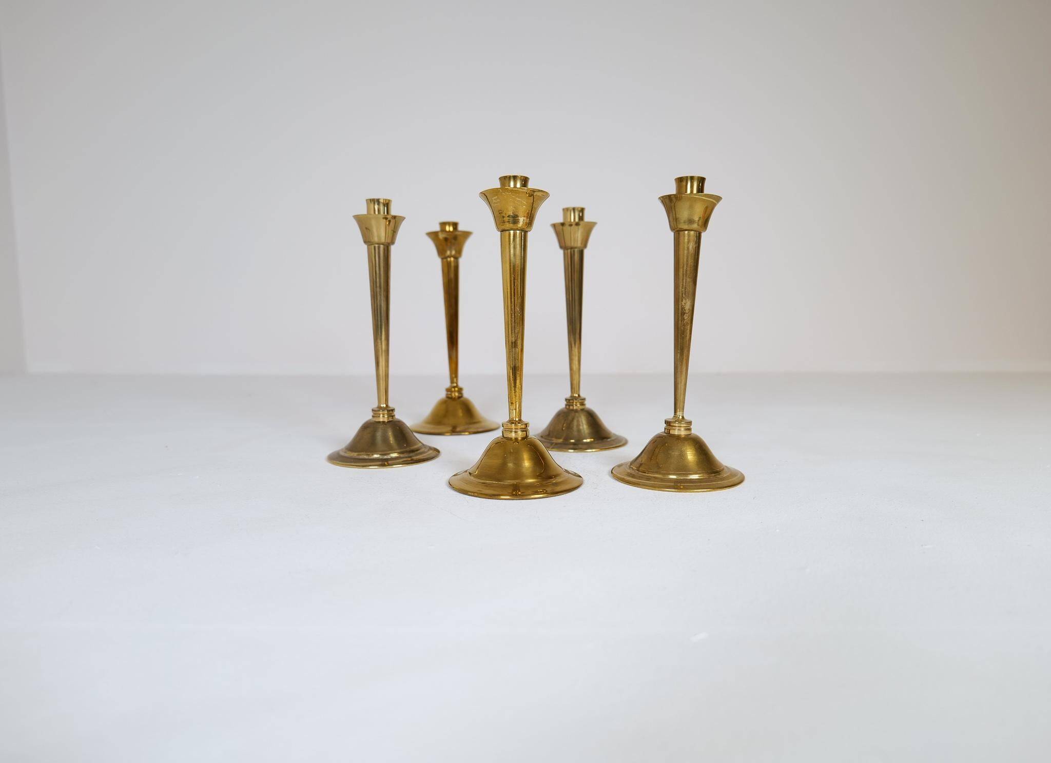 Mid-century set of 5 brass candlesticks by Lars Holmström, Arvika, Sweden.