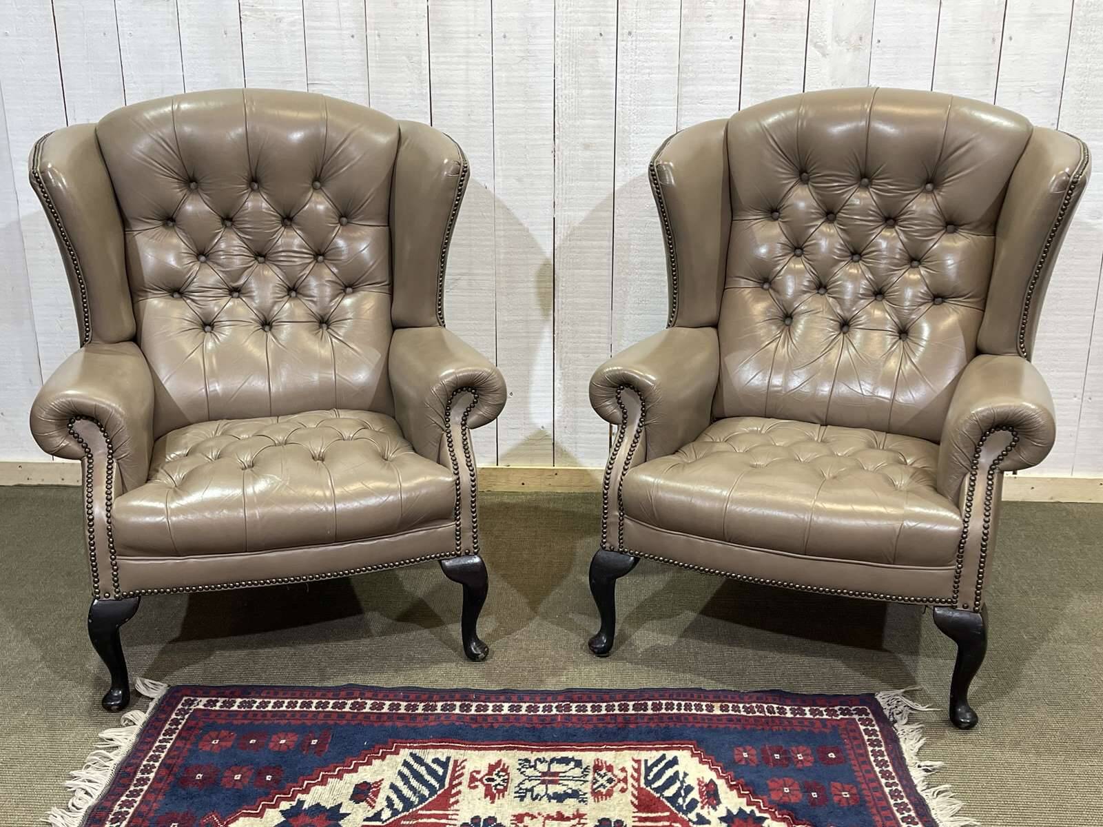 Pair of high-backed Chesterfield armchairs with 1 leather footrest