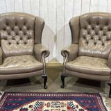 Pair of high-backed Chesterfield armchairs with 1 leather footrest