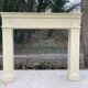 Fireplace surround with beige solid wood mantel