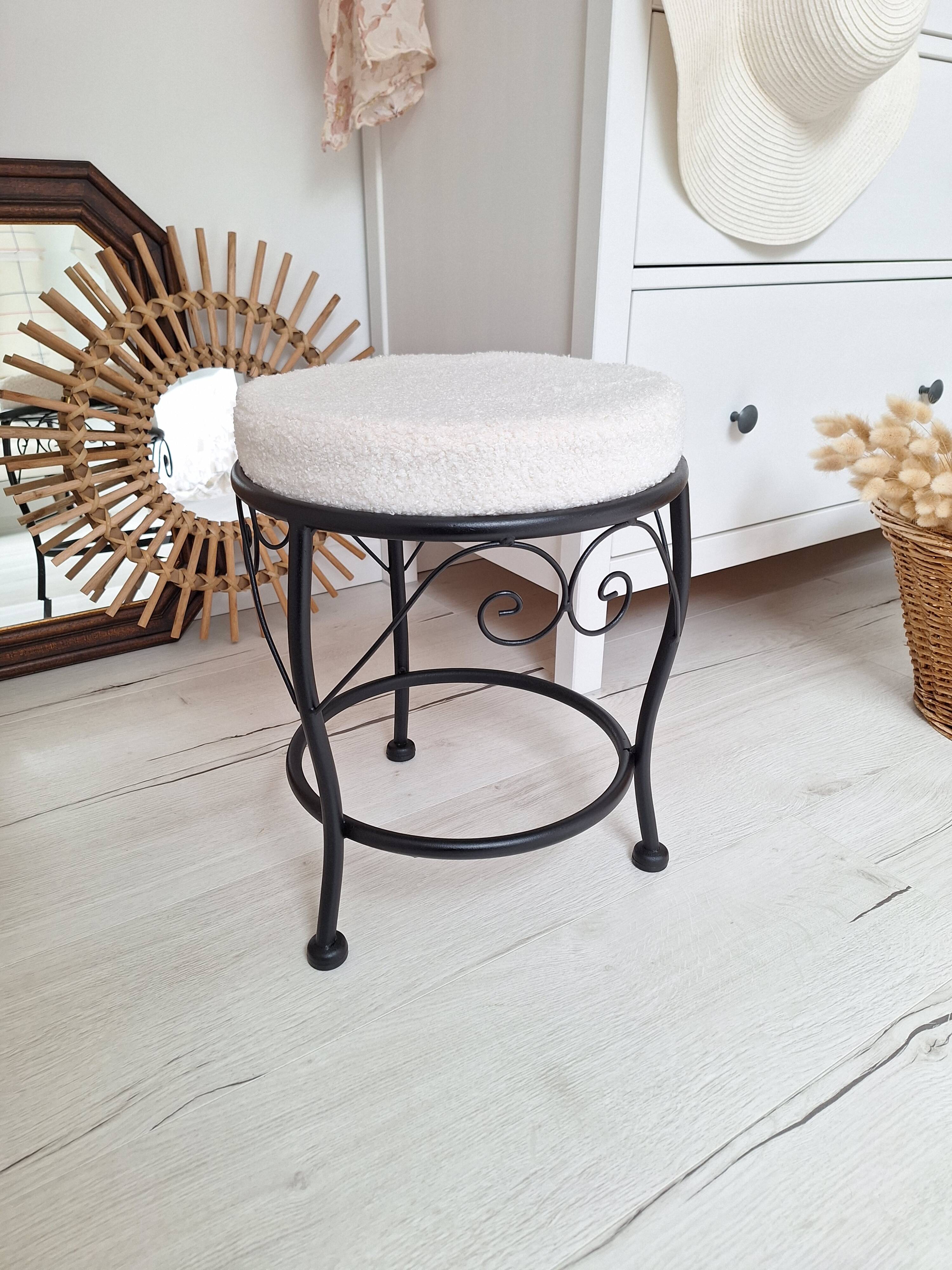 Black iron stool/pouf with its boucle fabric cushion.