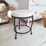 Black iron stool/pouf with its boucle fabric cushion.