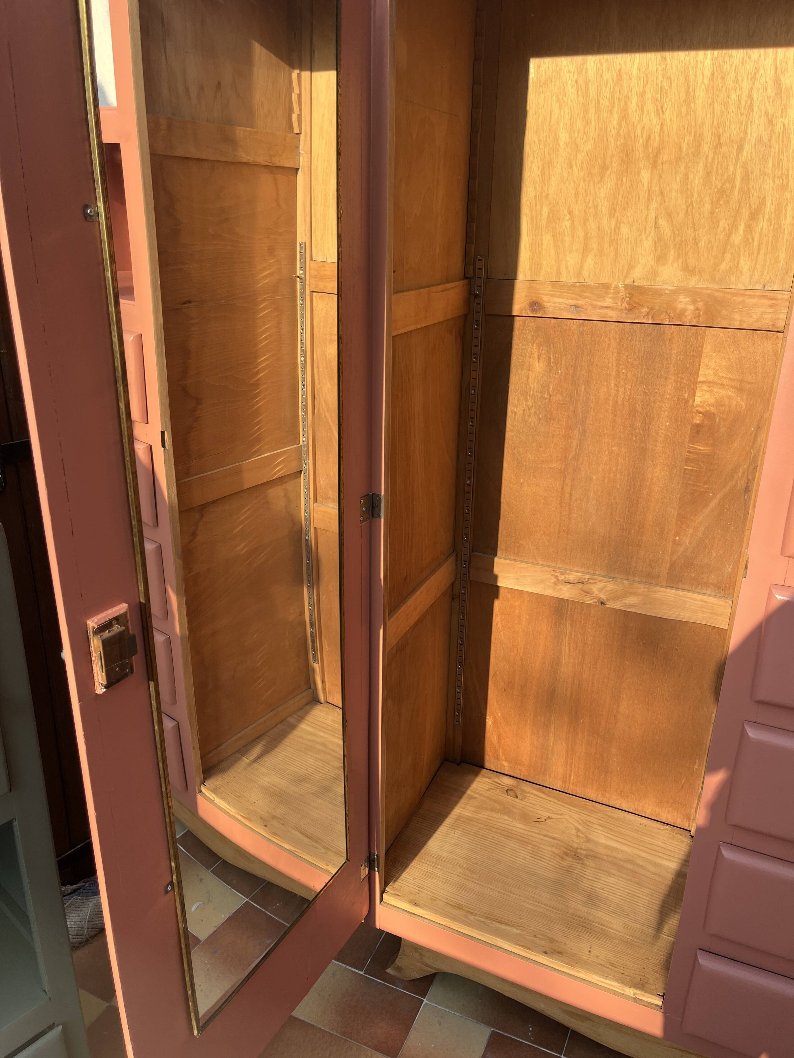 Asymmetrical vintage wardrobe painted in terracotta.