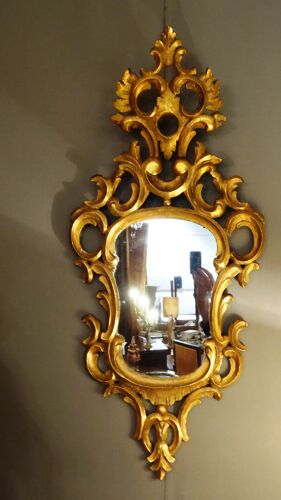 Miroir en bois sculpté et doré à la feuille d'or 46 x 103 cm