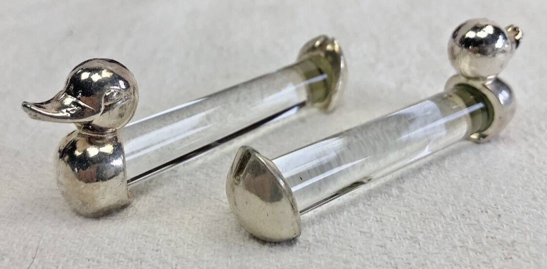 12 silver-plated metal duck knife rests with crystal.