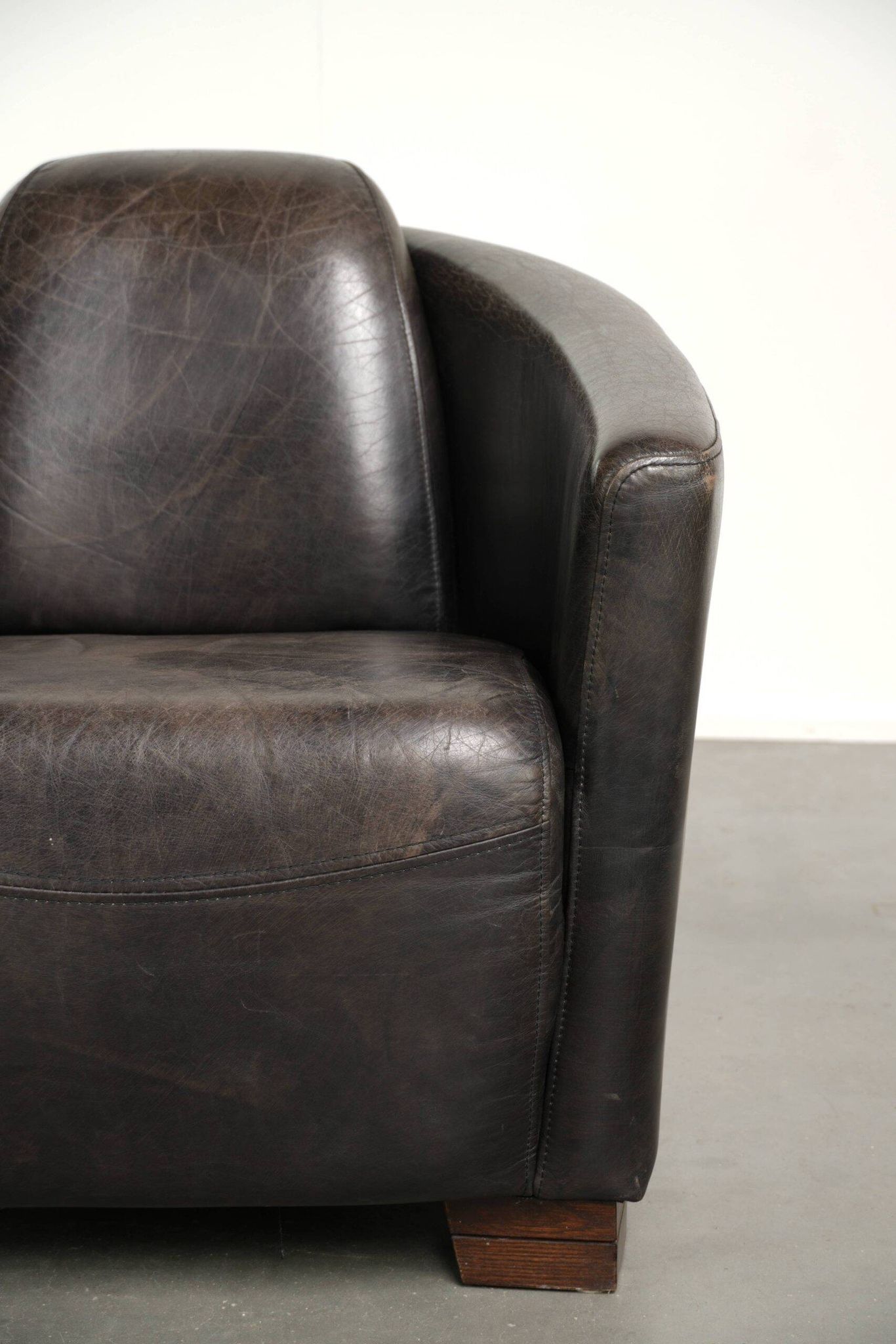 Cow leather Aviator design armchair in a dark colour scheme